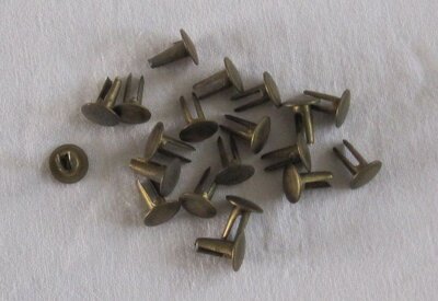 5 brass studs for retaining cash box lock.jpg